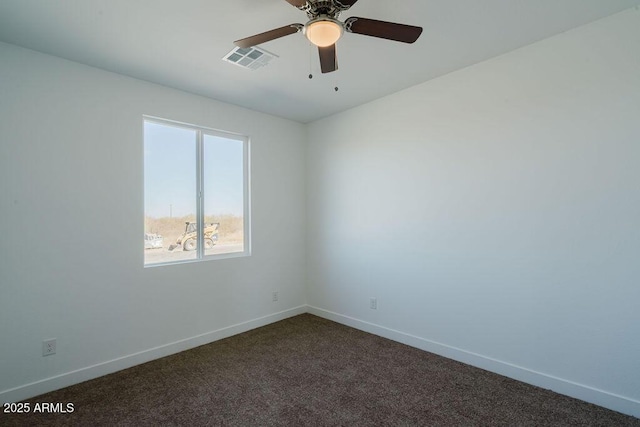 empty room with dark colored carpet and ceiling fan