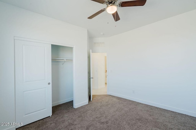 unfurnished bedroom with ceiling fan, carpet, and a closet