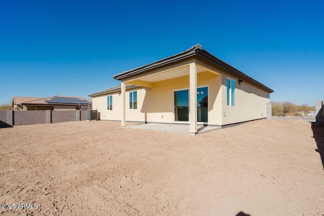 rear view of house with central air condition unit and a patio