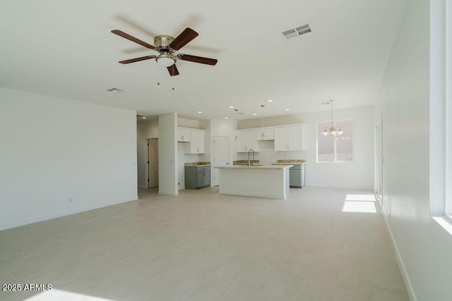 unfurnished living room with ceiling fan with notable chandelier and sink