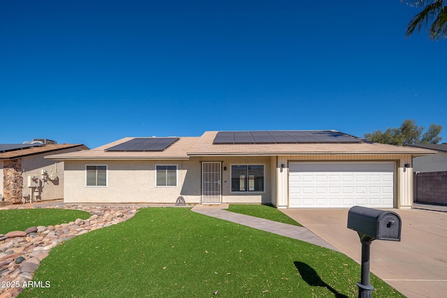 single story home with stucco siding, solar panels, concrete driveway, a front yard, and a garage