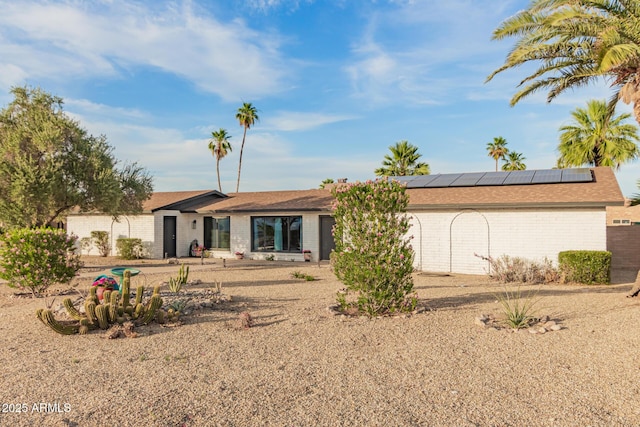 12866 W Orange Dr, Litchfield Park, AZ 85340 - view of front of house with brick siding and roof mounted solar panels