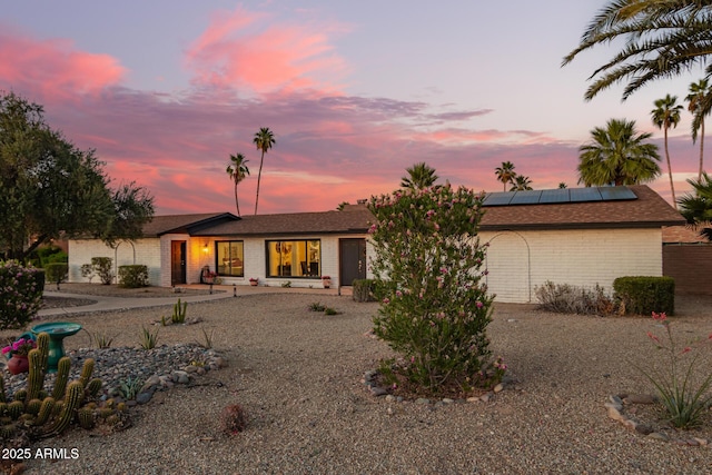 12866 W Orange Dr, Litchfield Park, AZ 85340 - view of front of home with roof mounted solar panels and brick siding
