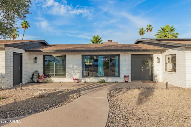12866 W Orange Dr, Litchfield Park, AZ 85340 - back of property with brick siding and roof with shingles