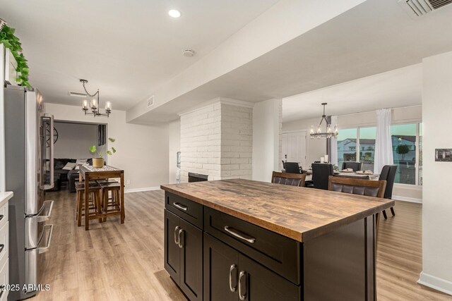 12866 W Orange Dr, Litchfield Park, AZ 85340 - kitchen featuring butcher block countertops, freestanding refrigerator, a chandelier, baseboards, and recessed lighting