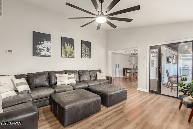 12866 W Orange Dr, Litchfield Park, AZ 85340 - living area with ceiling fan, lofted ceiling, light wood-type flooring, and a chandelier