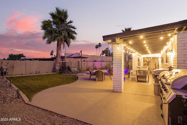 12866 W Orange Dr, Litchfield Park, AZ 85340 - patio terrace at dusk with a patio area, a fenced backyard, and a grill