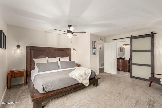 12866 W Orange Dr, Litchfield Park, AZ 85340 - carpeted bedroom with a barn door, baseboards, and ceiling fan