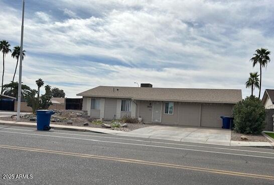 ranch-style home featuring a garage and concrete driveway