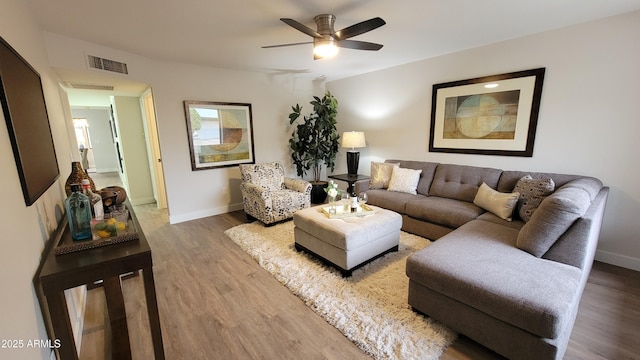 living room featuring hardwood / wood-style flooring and ceiling fan