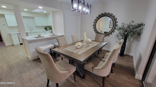 dining area with sink and light hardwood / wood-style floors