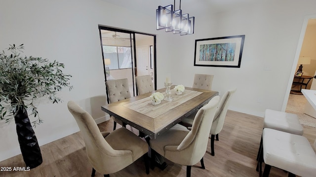 dining room featuring an inviting chandelier and light hardwood / wood-style flooring