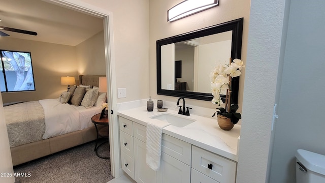 bathroom featuring vanity, toilet, and ceiling fan