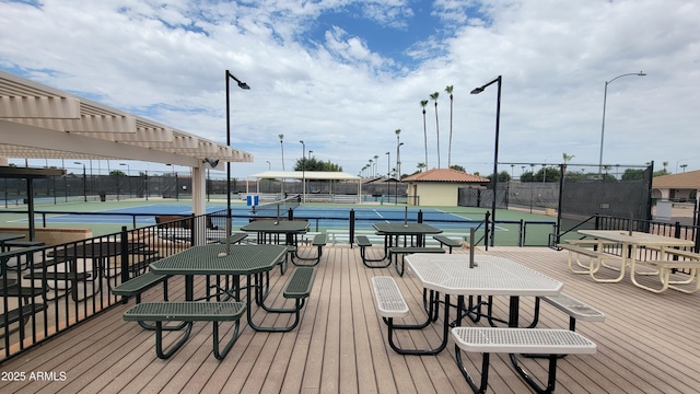 wooden deck featuring a pergola and tennis court