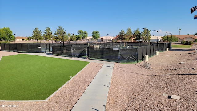 view of property's community featuring tennis court