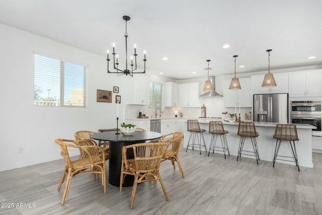 dining space with sink and an inviting chandelier