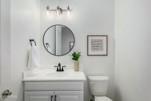 bathroom with toilet and vanity