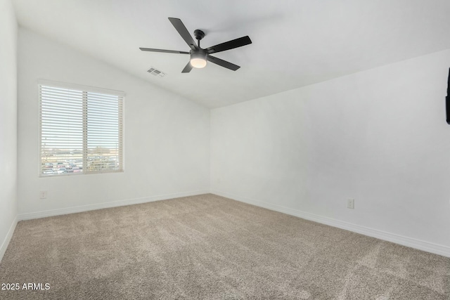 carpeted spare room featuring ceiling fan and lofted ceiling