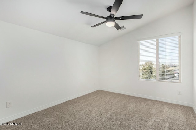 carpeted spare room featuring ceiling fan and lofted ceiling