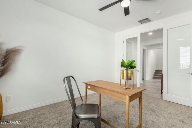 carpeted office featuring ceiling fan