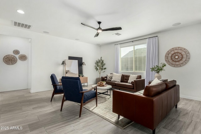 living room with ceiling fan and light hardwood / wood-style flooring