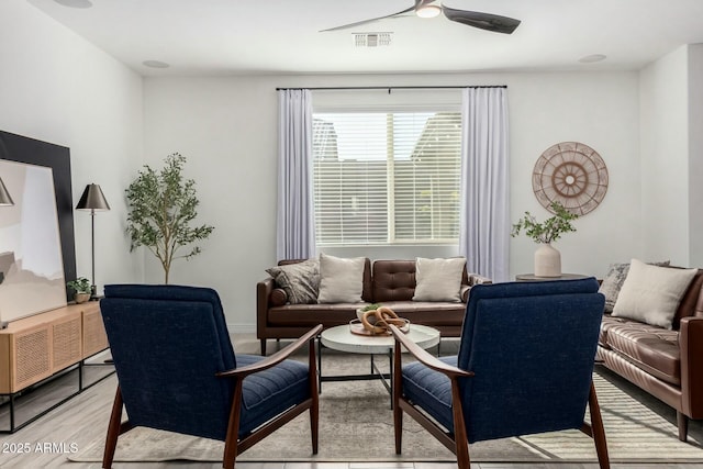 living room with ceiling fan and light wood-type flooring