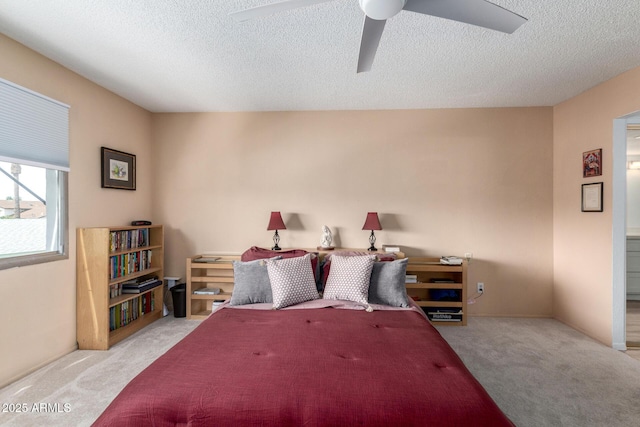carpeted bedroom featuring a textured ceiling and ceiling fan