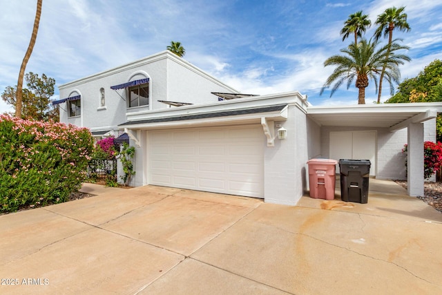view of front of property featuring an attached garage, driveway, and stucco siding