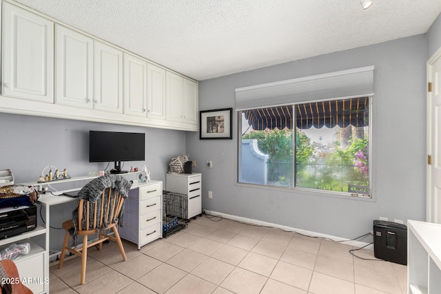 home office with light tile patterned floors and a textured ceiling