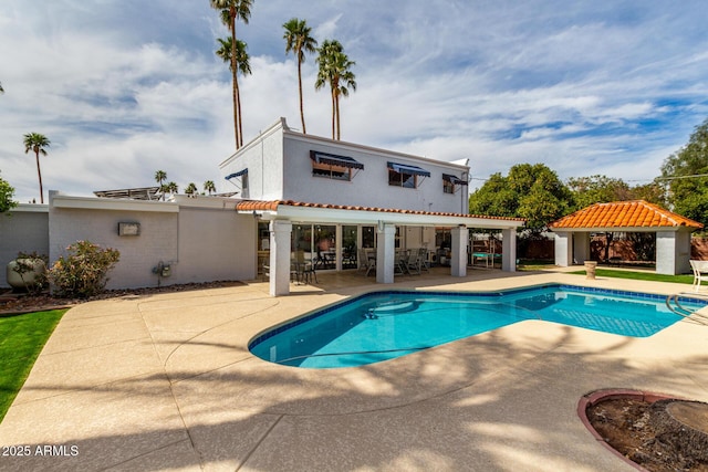 outdoor pool with a gazebo and a patio