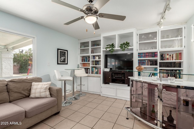 living room featuring light tile patterned floors, ceiling fan, and rail lighting