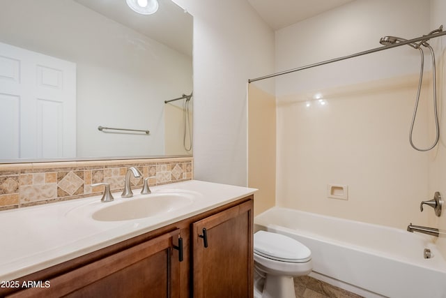 bathroom featuring toilet, tub / shower combination, and vanity