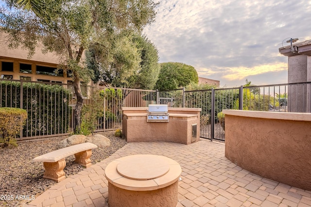 view of patio with area for grilling and fence