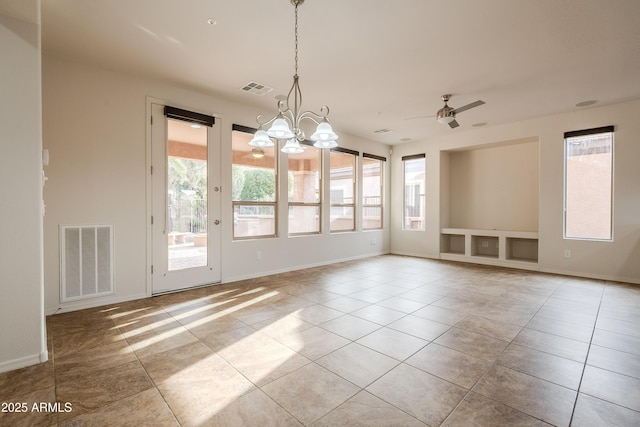 unfurnished dining area featuring visible vents, ceiling fan with notable chandelier, and a wealth of natural light