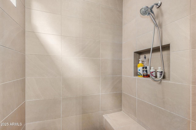 bathroom with a tile shower