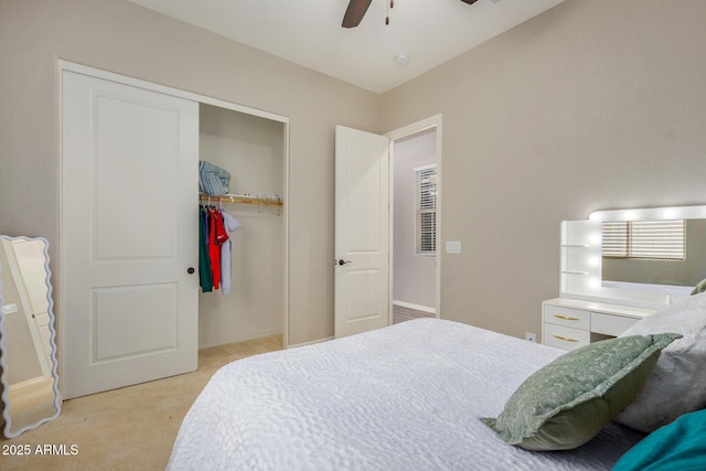 bedroom with ceiling fan, a closet, and light carpet