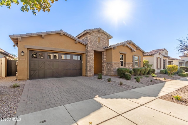 mediterranean / spanish-style house with a garage