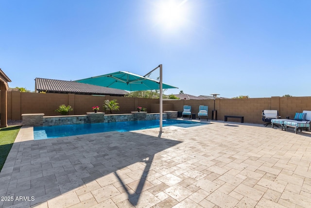 view of swimming pool with pool water feature and a patio