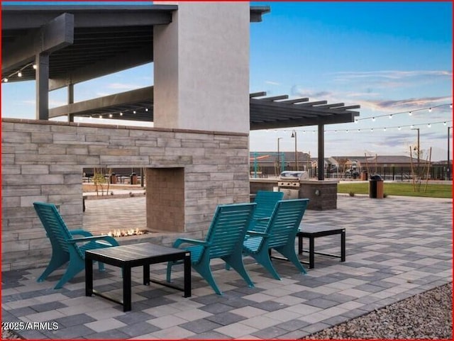 view of patio / terrace with exterior kitchen, grilling area, and a pergola