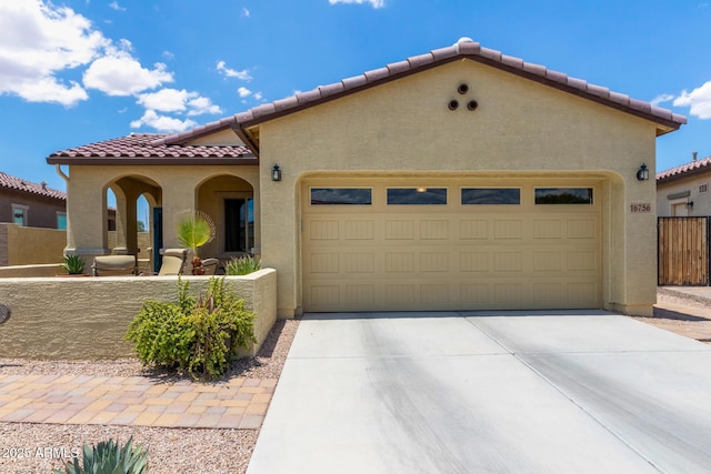 16756 S 181st Ln, Goodyear, AZ 85338 - mediterranean / spanish-style house featuring a tiled roof, stucco siding, an attached garage, and driveway