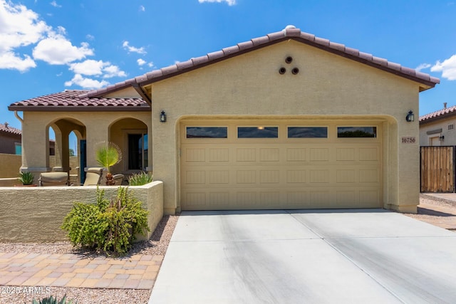 16756 S 181st Ln, Goodyear, AZ 85338 - mediterranean / spanish-style house with a tiled roof, an attached garage, stucco siding, and driveway