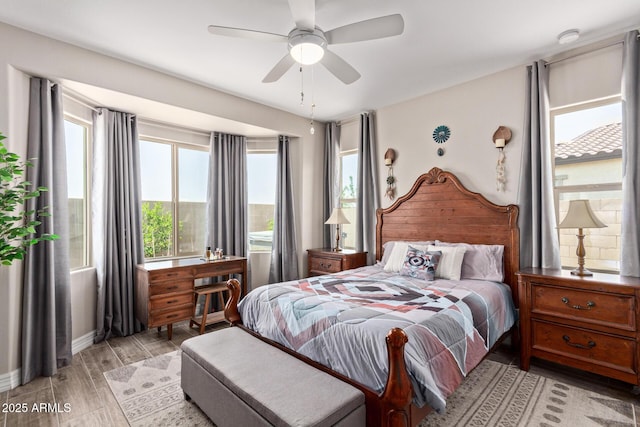 16756 S 181st Ln, Goodyear, AZ 85338 - bedroom with multiple windows, light wood-style flooring, and ceiling fan