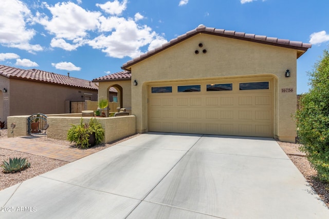 16756 S 181st Ln, Goodyear, AZ 85338 - mediterranean / spanish house featuring a tile roof, stucco siding, concrete driveway, and a garage