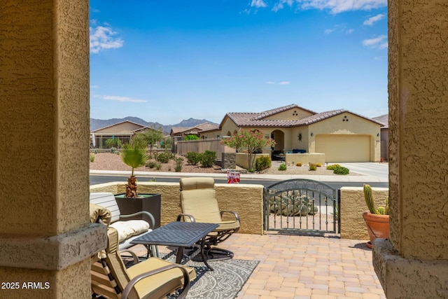 16756 S 181st Ln, Goodyear, AZ 85338 - view of patio / terrace featuring an attached garage, concrete driveway, and a mountain view