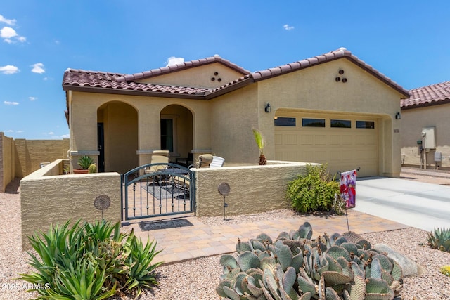 16756 S 181st Ln, Goodyear, AZ 85338 - mediterranean / spanish-style home featuring a gate, a fenced front yard, stucco siding, and an attached garage