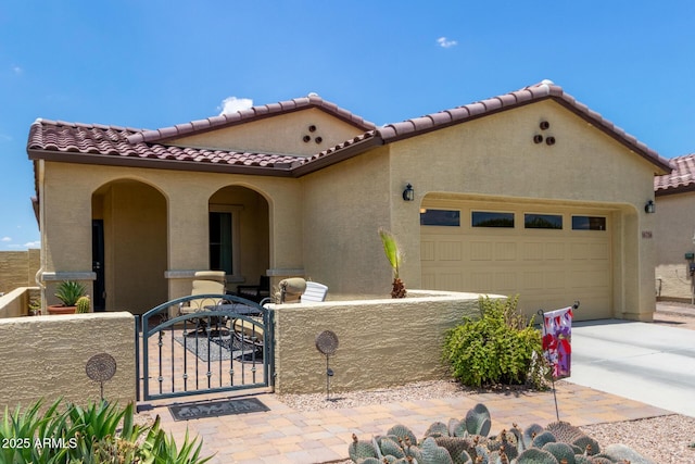16756 S 181st Ln, Goodyear, AZ 85338 - mediterranean / spanish home with a tile roof, a gate, a garage, and stucco siding