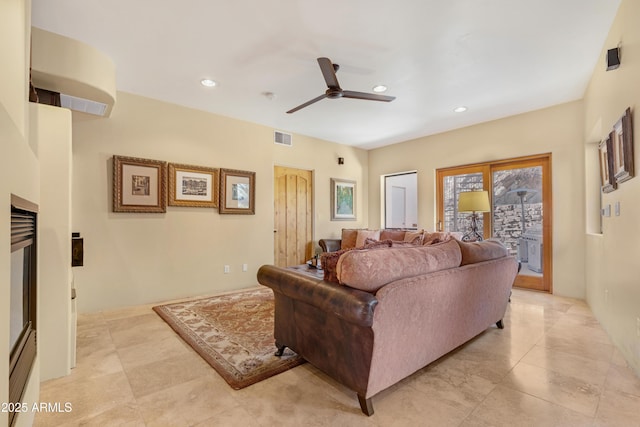 living room with visible vents, a ceiling fan, and recessed lighting