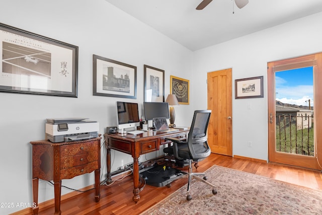 office space featuring a ceiling fan, baseboards, and wood finished floors