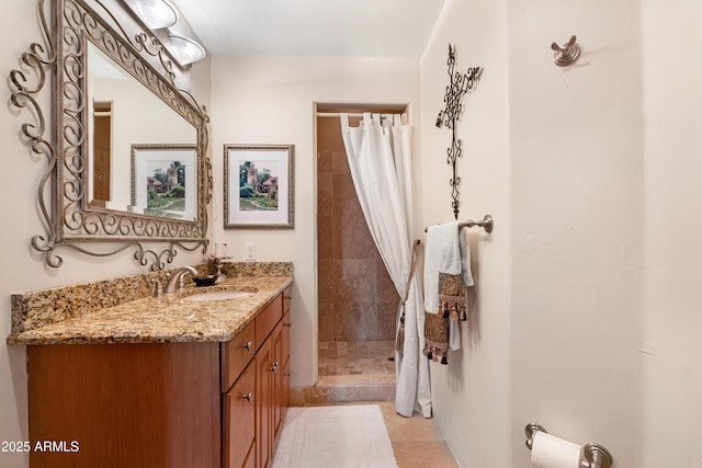 bathroom featuring curtained shower, vanity, and tile patterned flooring