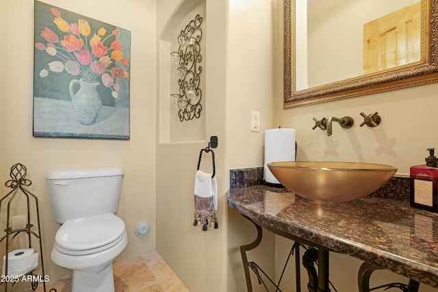 bathroom featuring sink and toilet